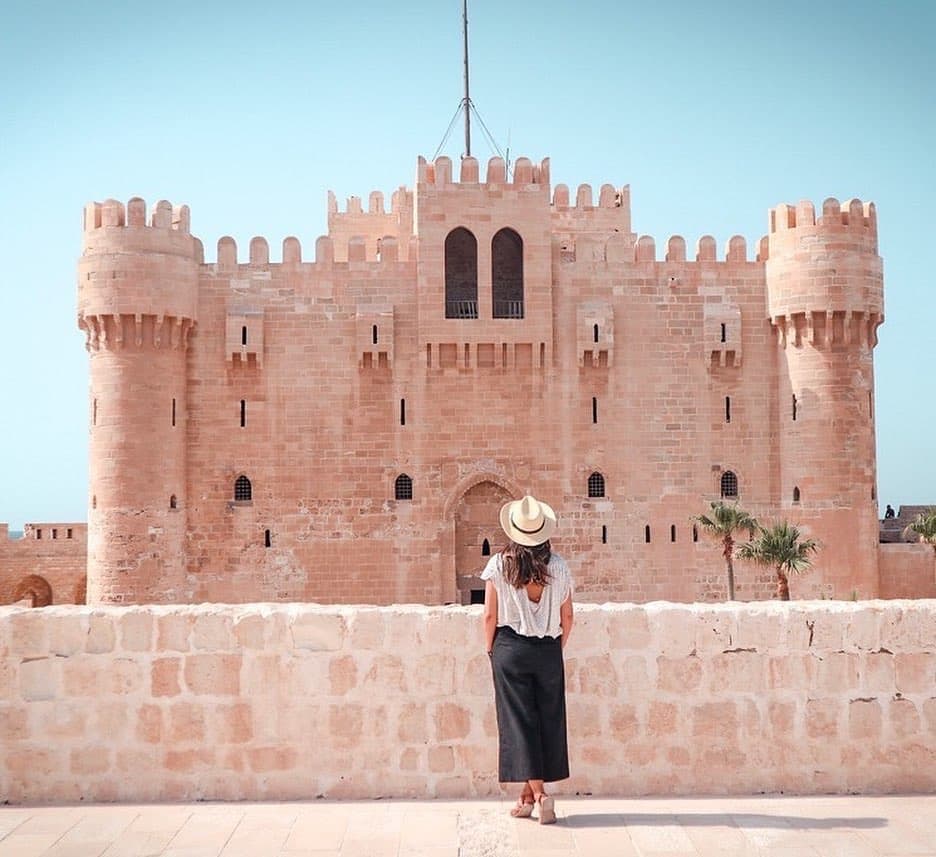 Interior of a building with columns and flags