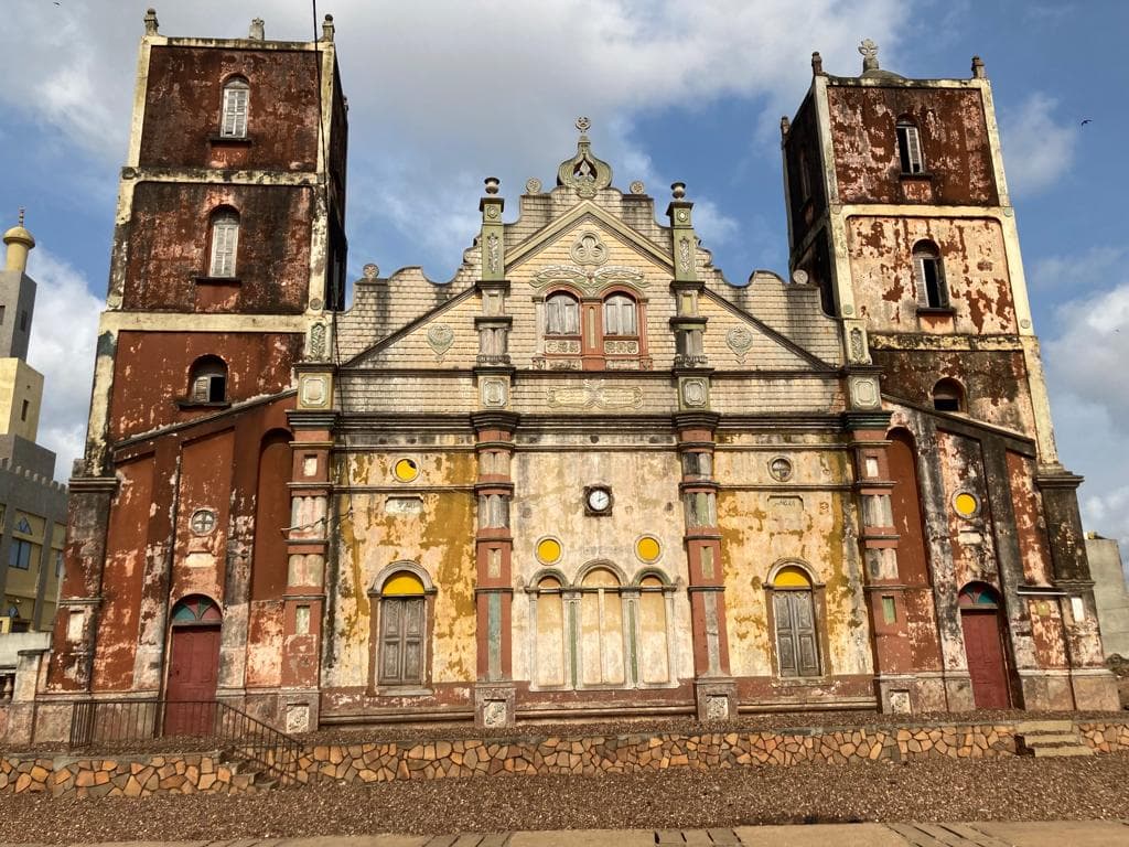 Interior of a building with columns and flags