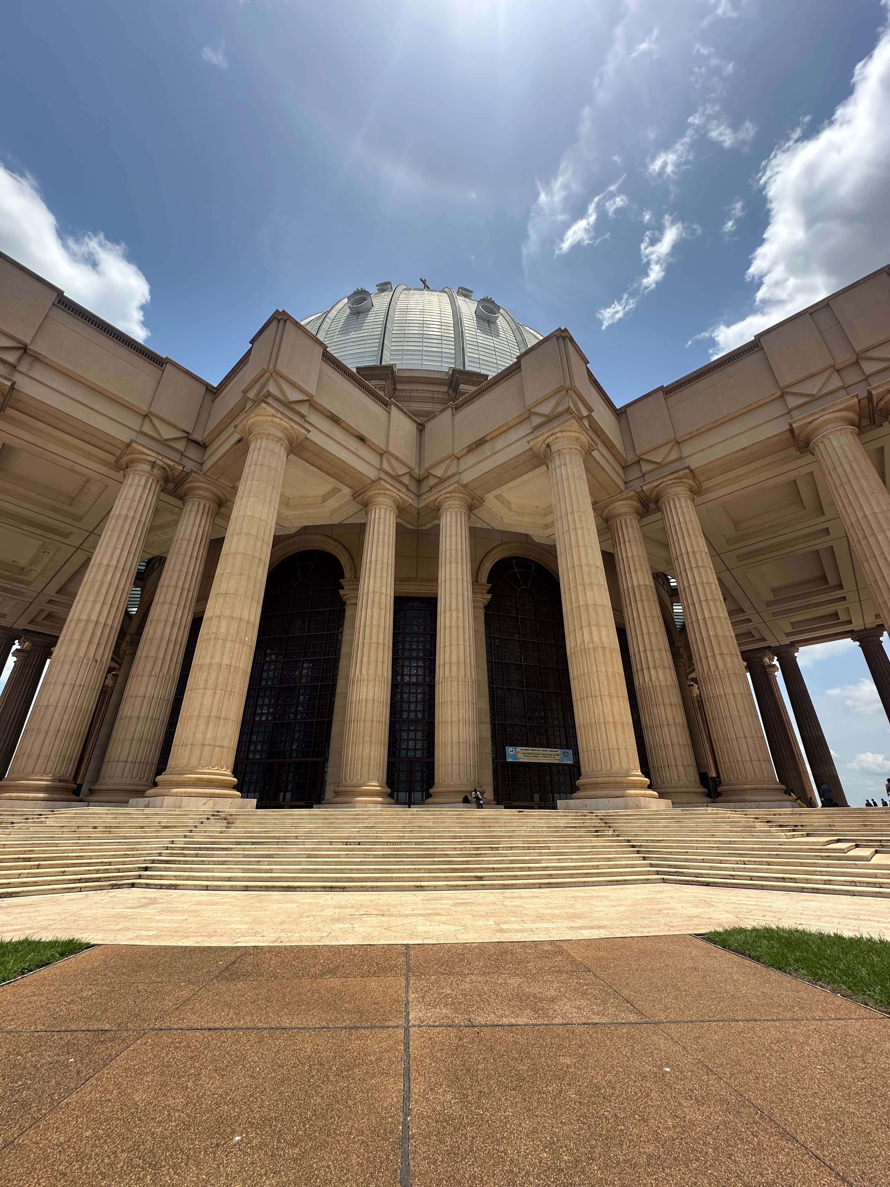 Interior of a building with columns and flags